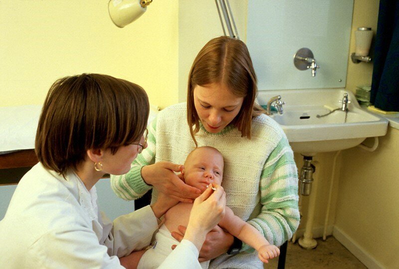 Image: Baby receiving oral polio vaccine, Credit: Anthea Sieveking , Wellcome Images
